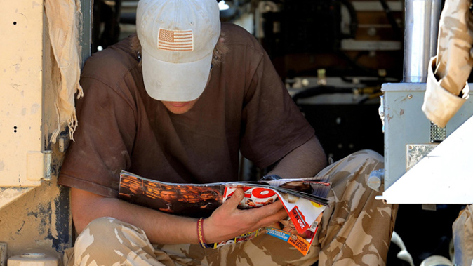 Prince Harry having a read of Zoo magazine while on deployment in Afghanistan (Getty Images)