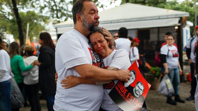 Luis Fabiano and Flavia Farias, relatives of British journalist Dom Phillips' wife, embrace during a protest following the disappearance of Phillips and an indigenous expert. Photo / AP
