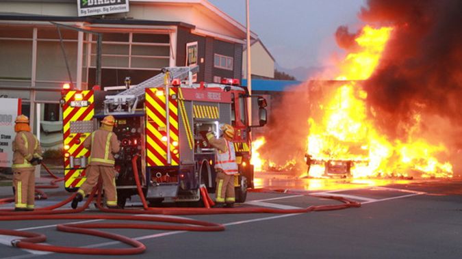 Fire crews battle the blaze after a truck carrying gas cylinders caught fire in Nelson. (NZME./Andrew Board)