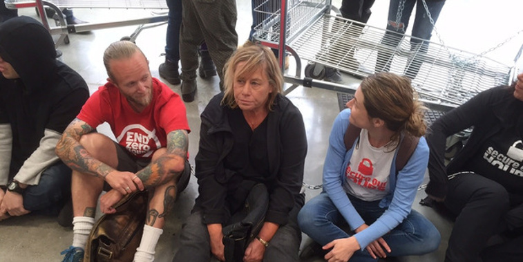 Activist Sue Bradford and other protesters chain themselves to Bunnings in Grey Lynn (New Zealand Herald)