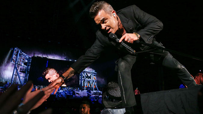 Robbie Williams reaching out to fans at the Basin Reserve (Getty Images)