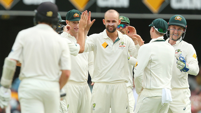 Nathan Lyon congratulated by teammates on taking a wicket. (Getty Images)