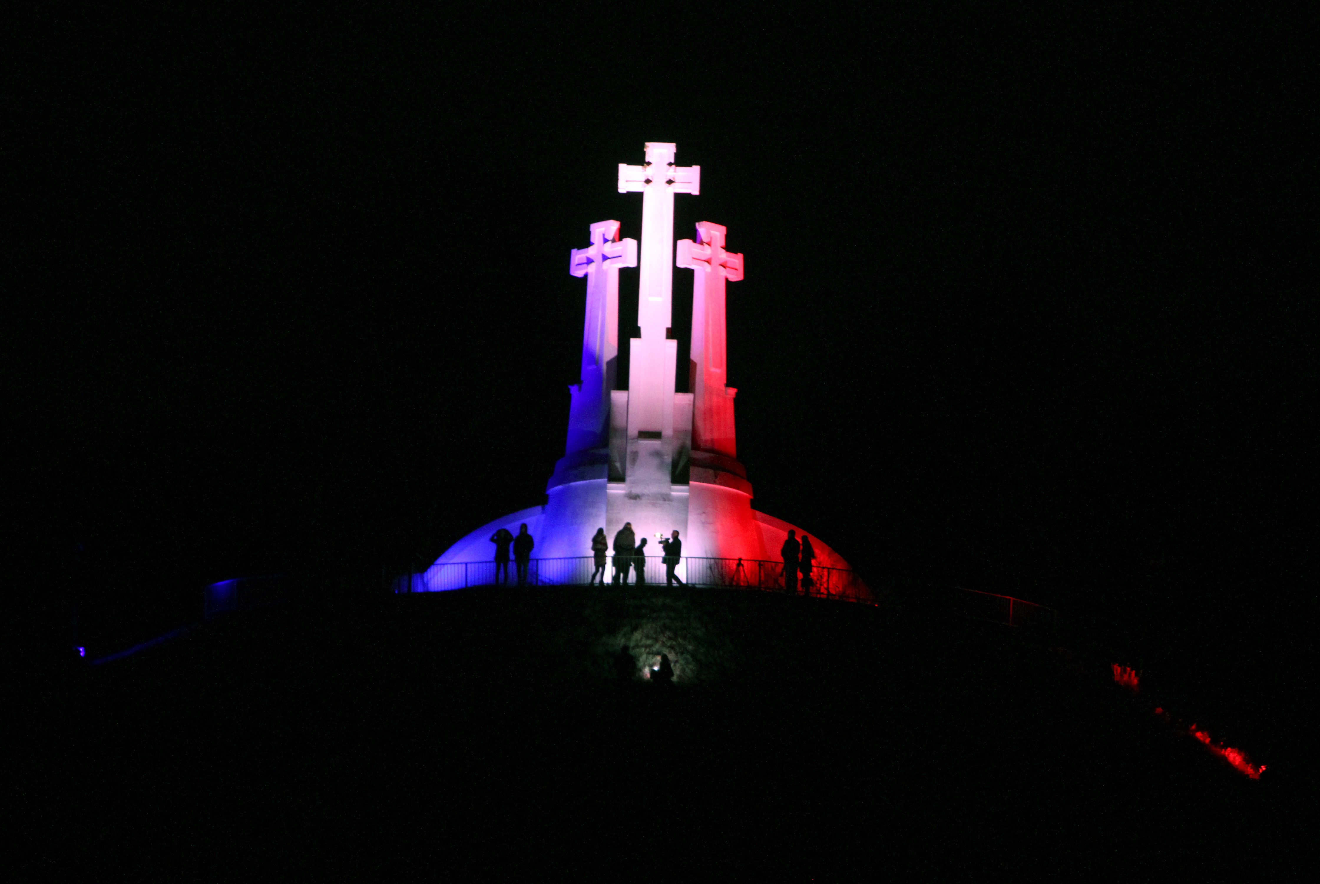 The three Crosses monument is illuminated in French national colors in Vilnius, Lithuania