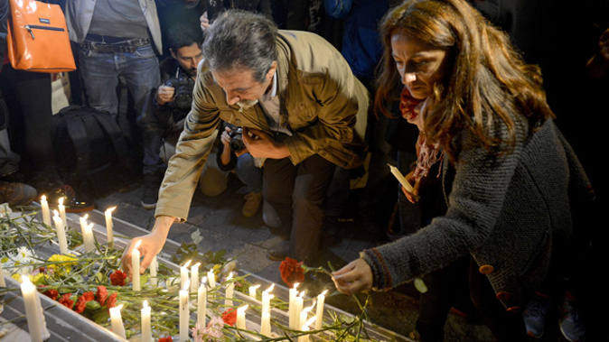 Turkish people leave flowers and candles in front of the French embassy in Istanbul. (Getty Images)