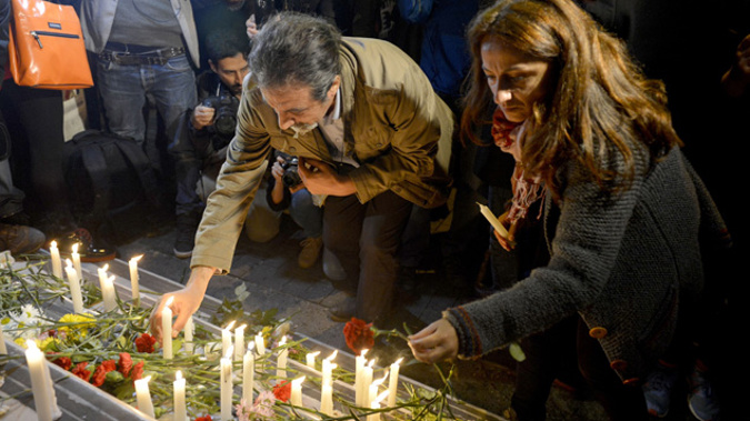 Turkish people leave flowers and candles in front of the French embassy in Istanbul. (Getty Images)