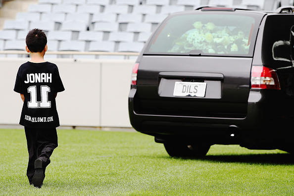 Dhyreille Lomu follows the hearse as it departs