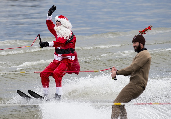 A man dressed as Santa water skiing on the Potomac River in the USA.  