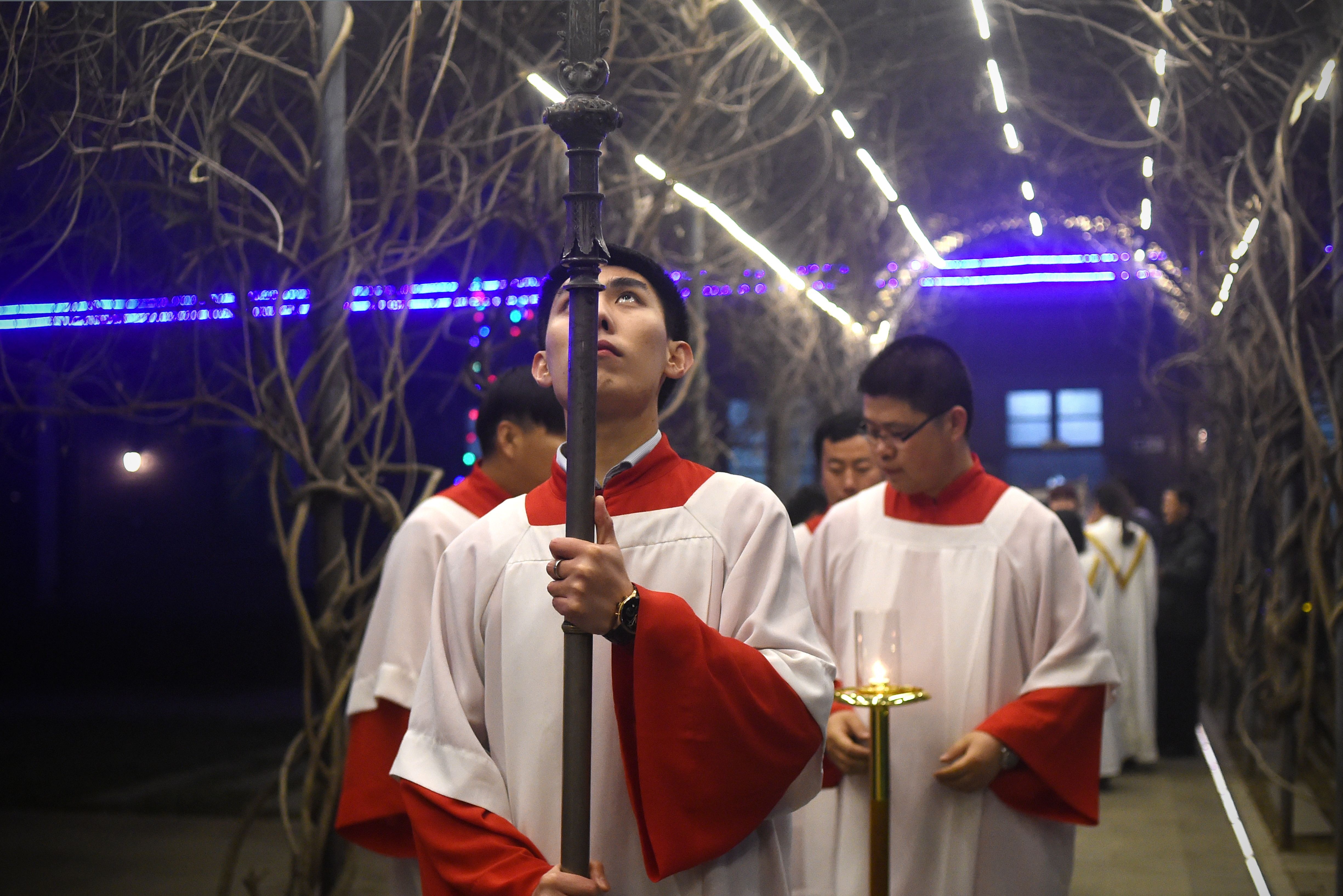 Cross bearers enter a Catholic church in Beijing, China. 