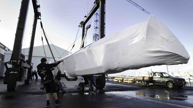 One of Team New Zealand's catamaran hulls arrives at the old Auckland base, 2012. (Photo: NZHerald)