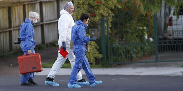 Yesterday officers in forensic suits worked behind the cordon (NZ Herald)