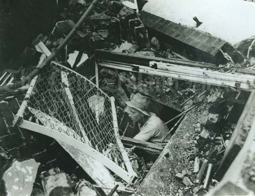 A man emerging from rubble (NZ History) 