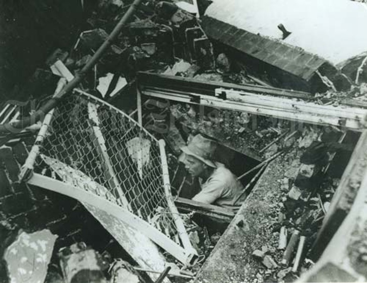 A man emerging from rubble (NZ History)