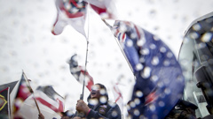 Protesters braving the rain at Waitangi (NZ Herald)