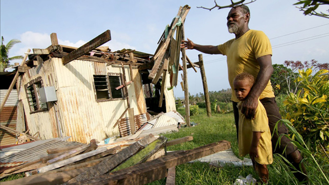 A man gestures towards his damaged house after Cyclone Winston (Getty Images)
