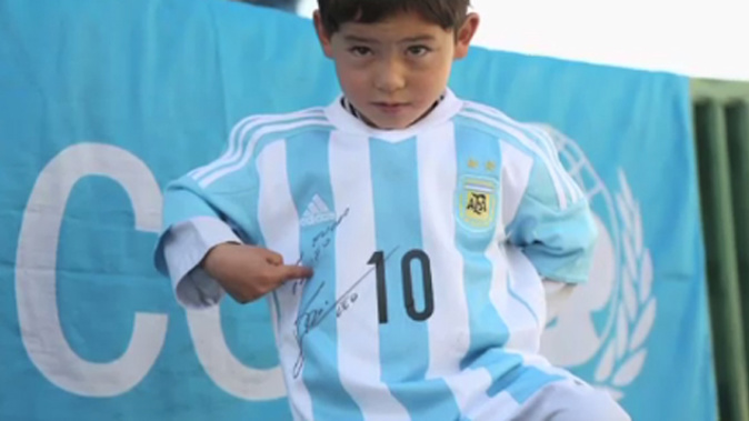 Murtaza Ahmadi with his signed Argentina shirt sent by Lionel Messi (CNN)