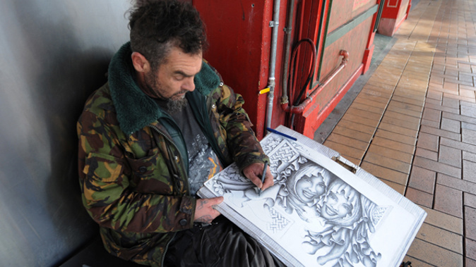A homeless man in Wellington drawing a picture (Getty Images)