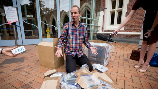 Nicky Hager with his destroyed computer outside Auckland High Court today (NZH).