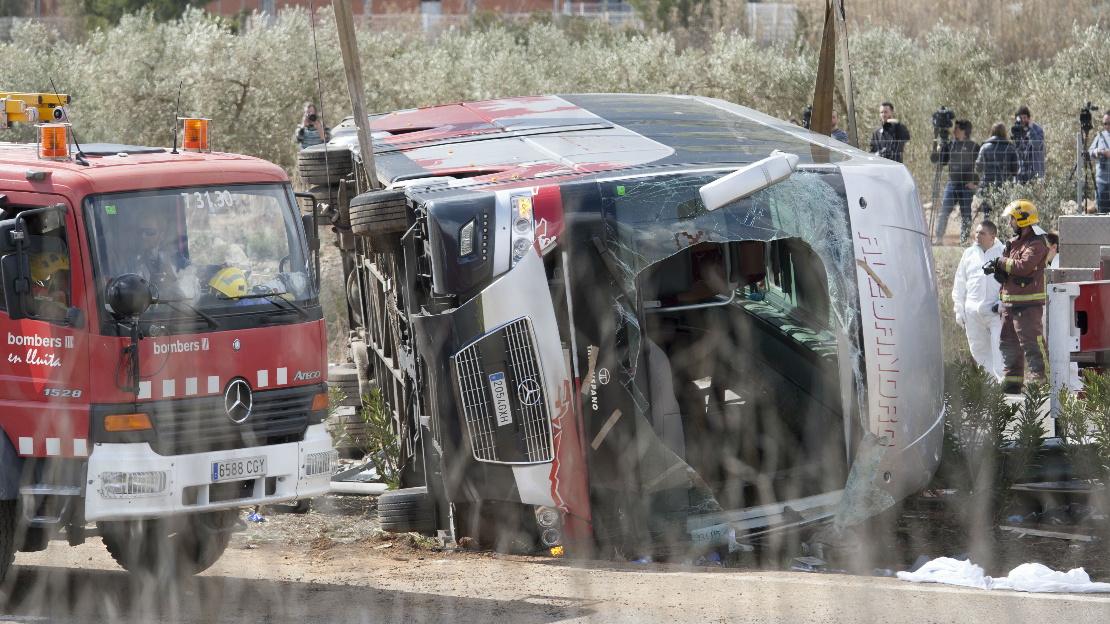 Fire trucks are seen at the scene of an accident after a bus carrying university exchange students back from a popular festival crashed near Tarragona in north-east Spain (Getty Images)