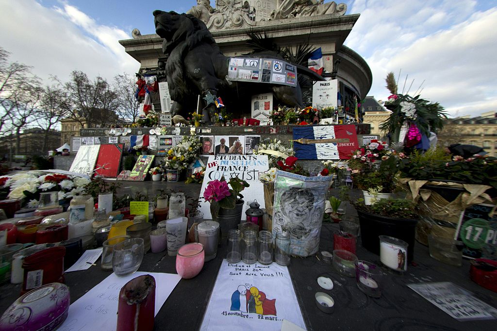 Floral tributes, candles, notes and a drawing by French cartoonist Plantu, at the Place de la Republique in Paris 