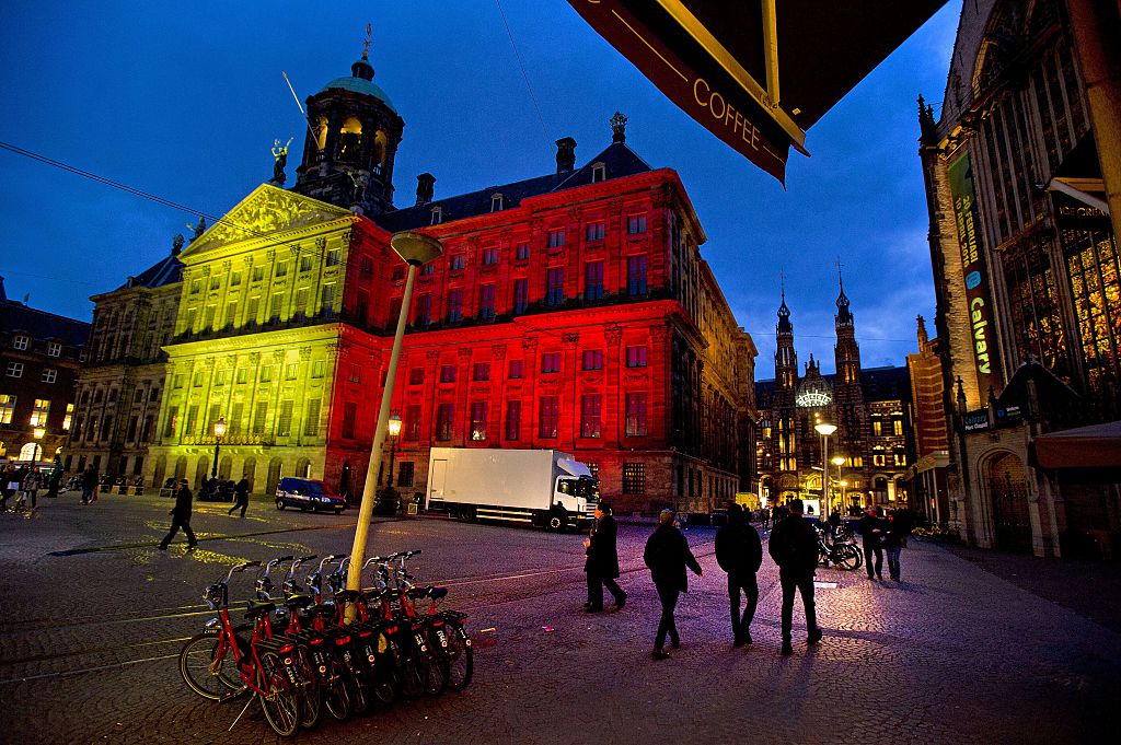 the Royal Palace at Dam Square in Amsterdam displaying the colors of the Belgian flag