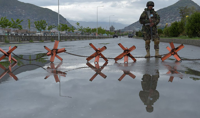 An Afghani soldier stands guard at a roadblock (Getty Images) 