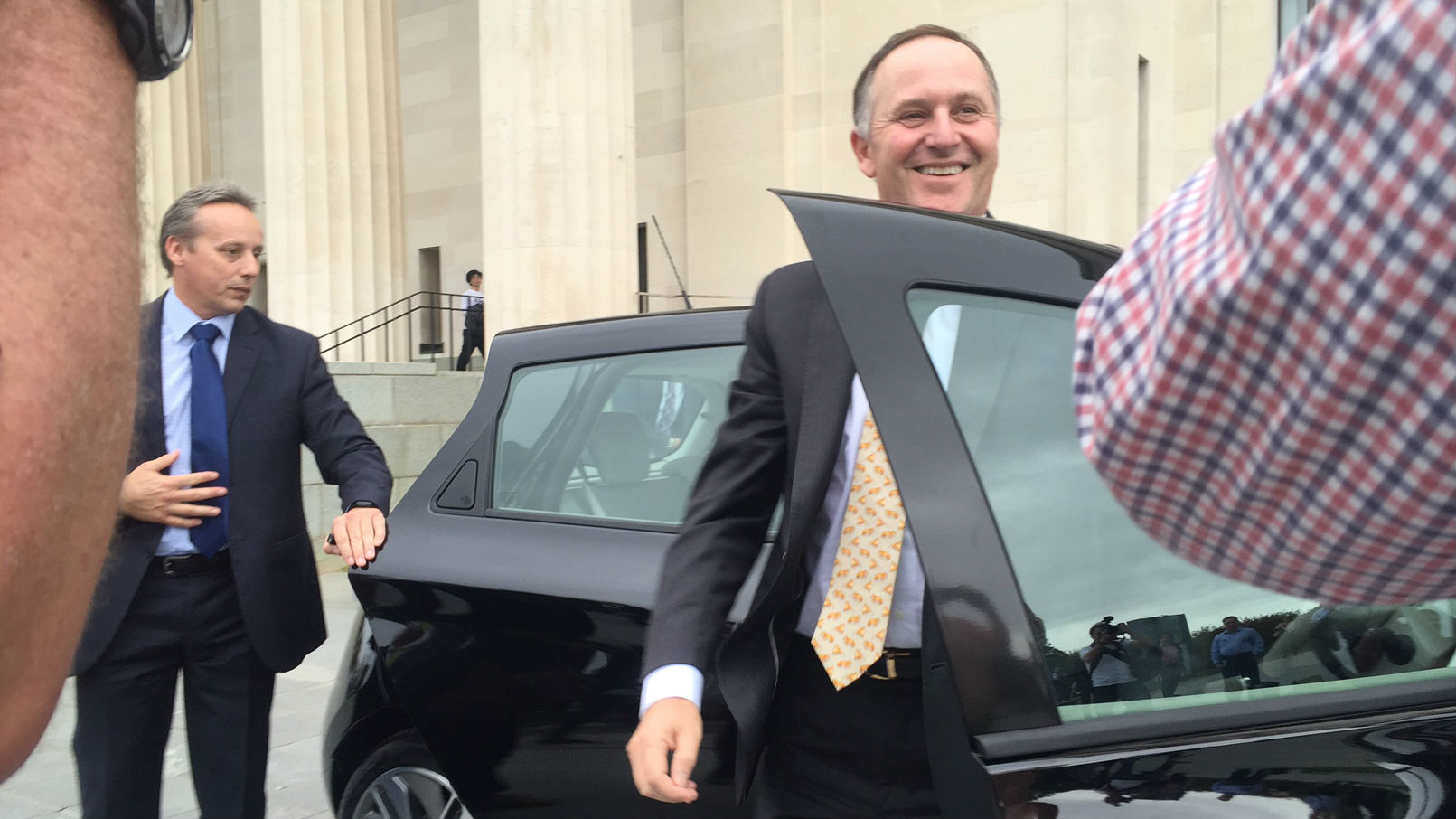 John Key getting out of an electric car yesterday (Photo / Gia Garrick).