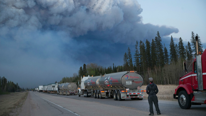 Drivers wait for clearance to take firefighting supplies into town outside of Fort McMurray, Alberta.  (Photo / Getty Images)