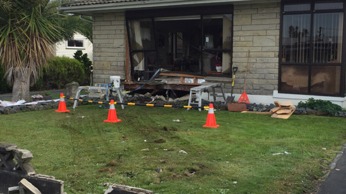 The damage left after the car was removed from the front of the house (Belinda Feek).