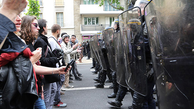 Protesters face a police cordon in Paris (Getty Images) 