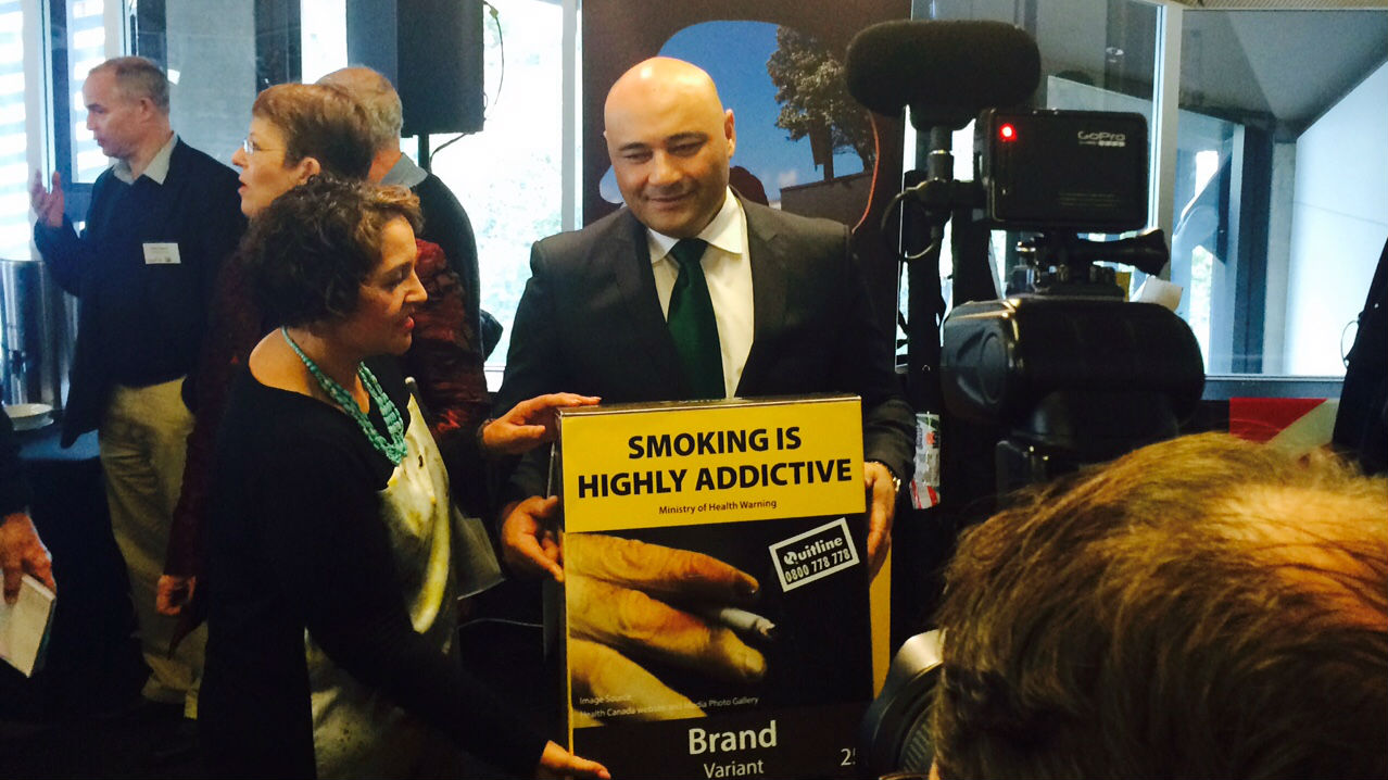 Associate Health Minister Sam Lotu-Iiga and Maori Party co-leader Marama Fox with an example of how cigarette packs could soon look (Photo / Nicholas Jones)