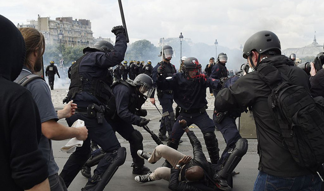 French riot police deal to a protester near the Invalides in Paris (Getty Images)
