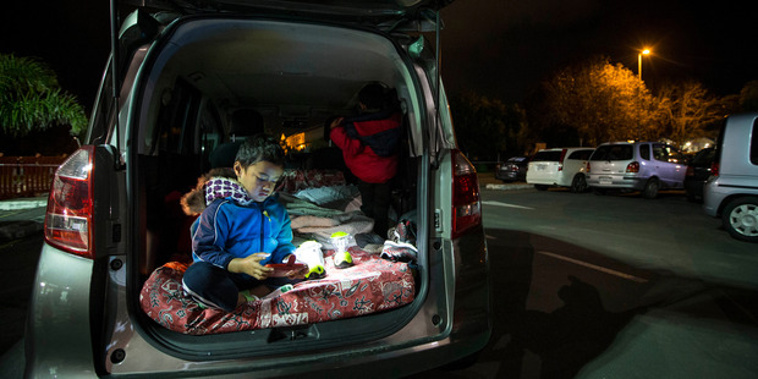 Setima Autagavaia, 4, in the back of his family vehicle for Park Up for Homes in Mangere Town Centre car park. Photo / Jason Oxenham