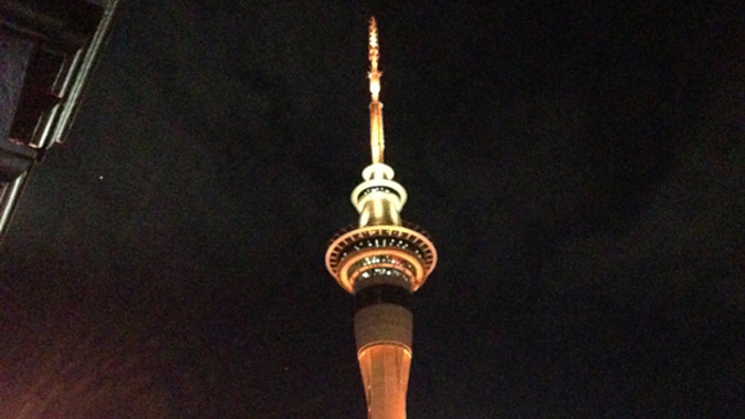 Auckland's Sky Tower lit orange and yellow for Matariki (Emma Stanford).