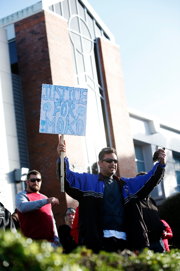 Man holding a sign at the Whangarei March for Moko (Alan Dinsdale) 