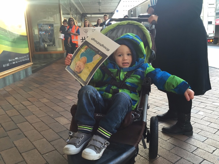 Child holding a sign in Dunedin (Matiu Workman)