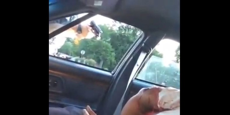 Part of the video which shows a police offer pointing a gun through the window of the car, and Castile's bloodied body slumped over (Supplied)