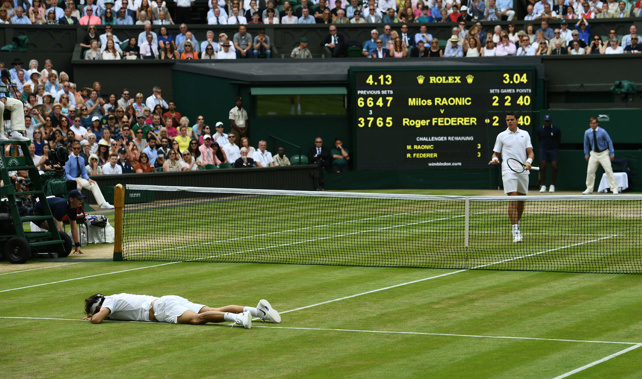 Federer has a lie down after taking a serve from Raonic (Getty Images)