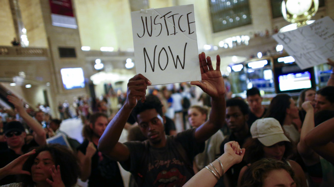 People take part in a protest in Grand Central Station in New York City. Police presence was increased around New York City after five police officers were killed in a shooting in Dallas (Photo / Getty Images)