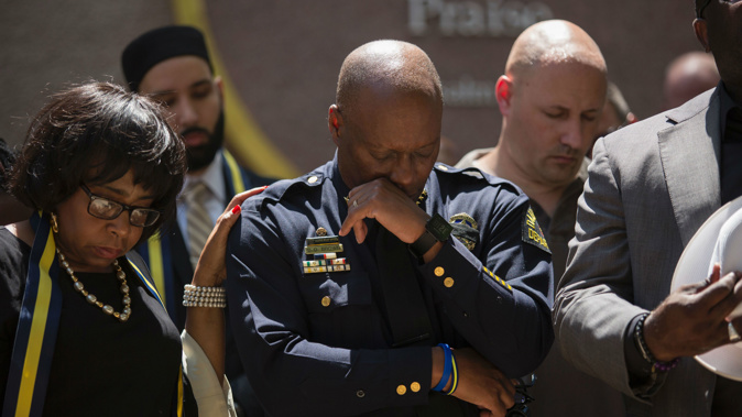 Dallas Police Chief David Brown prays during a a vigil at Thanks-Giving square in Dallas, following the shootings during a peaceful protest which left 5 police officers dead (Photo / Getty Images)