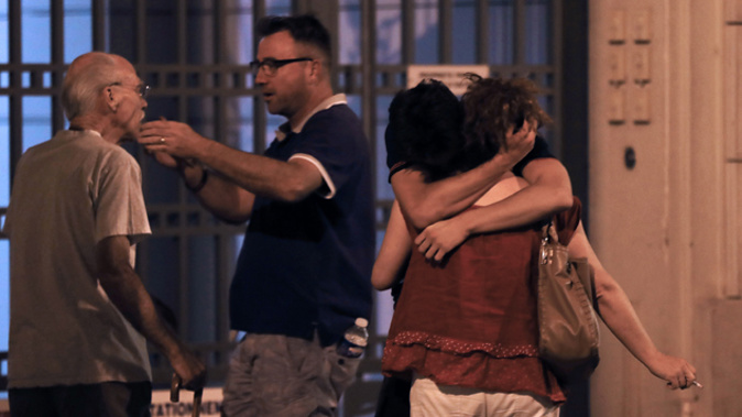 People in Nice embrace after surviving the horrific attack