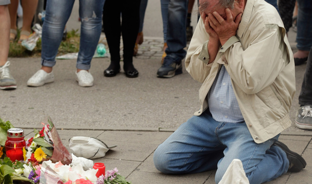 A mourner at the scene of a mass shooting in Munich (Getty Images) 