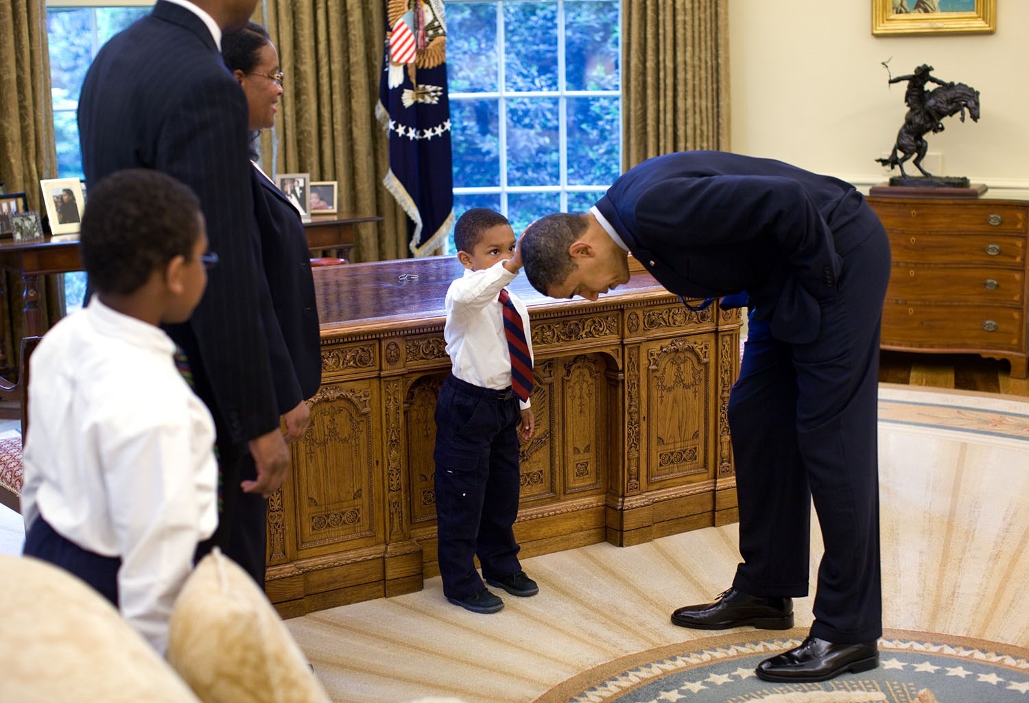 May 8, 2009 “A temporary White House staffer, Carlton Philadelphia, brought his family to the Oval Office for a farewell photo with President Obama. Carlton’s son softly told the President he had just gotten a haircut like President Obama, and asked if he could feel the President’s head to see if it felt the same as his.”