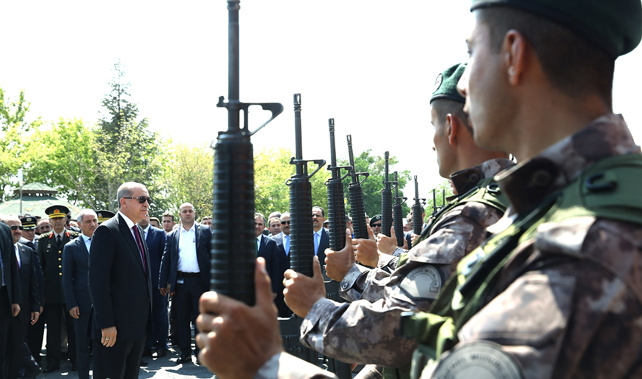 Turkish President Recep Tayyip Erdogan (L) salutes police officers in Ankara (Getty Images) 