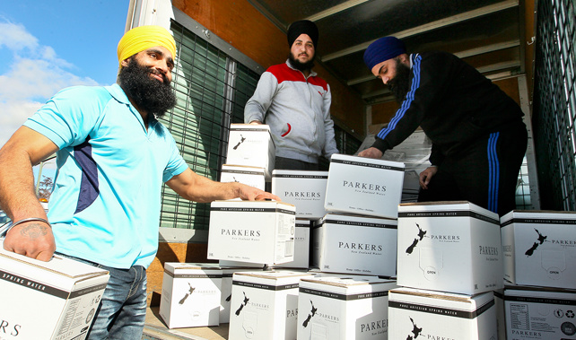 Members of the Hastings Sikh Society unloading free drinking water they have donated for the Havelock North community (Warren Buckland)