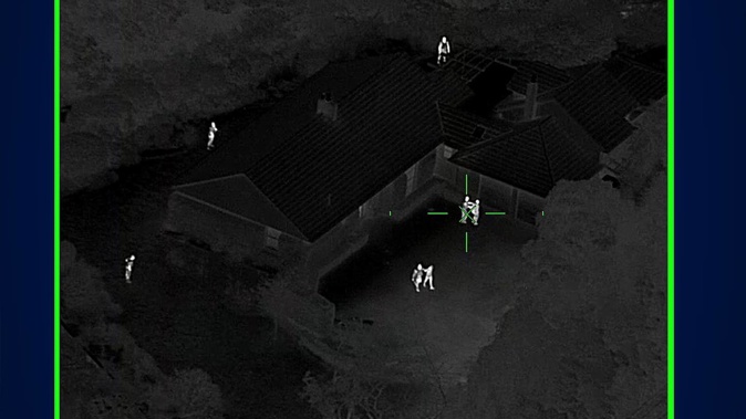 Nght vision captures the moment Auckland Police's Eagle Helicopter oversees the capture of two men at a Howick property. (Photo / Supplied)