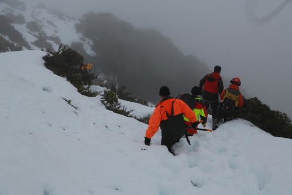 The recovery team searching for the body of a man who died after falling down a bank (Supplied) 