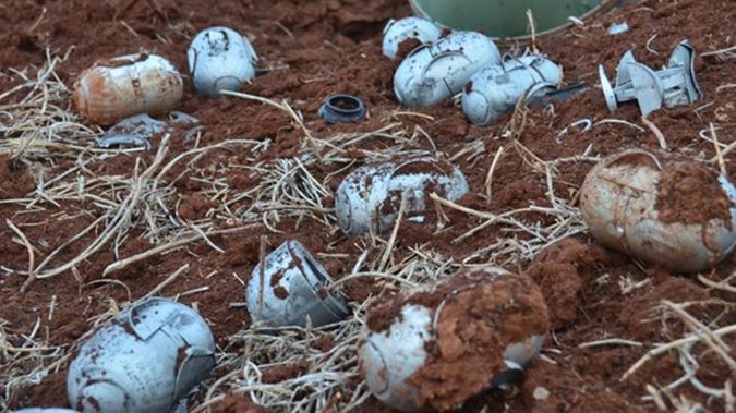 Alleged shrapnels of a cluster bomb are seen on the ground near Aleppo, Syria. (Getty Images).