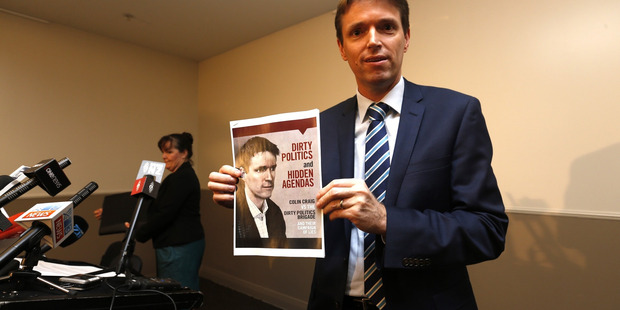 Colin Craig holds the booklet in which he allegedly defamed Tax Payers Union executive director Jordan Williams. Photo / Dean Purcell NZ Herald
