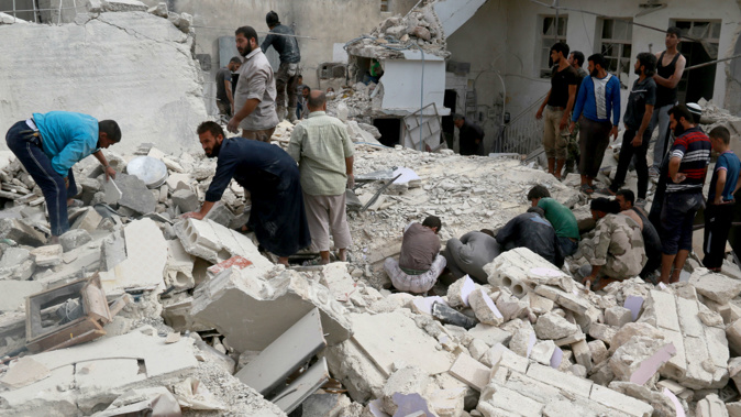 People inspect the debris of a building after warcrafts belonging to Syrian and Russian army carried out an airstrike on opposition controlled residential area at Merce neighborhood of Aleppo, Syria (Photo / Getty Images) 