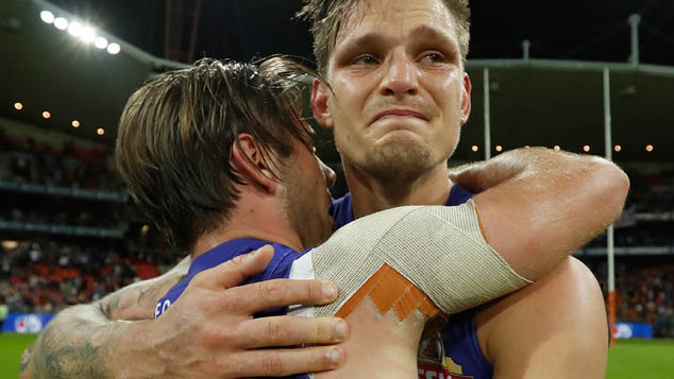 Western Bulldogs players Caleb Daniel and Clay Smith embrace after the final siren (Getty Images)